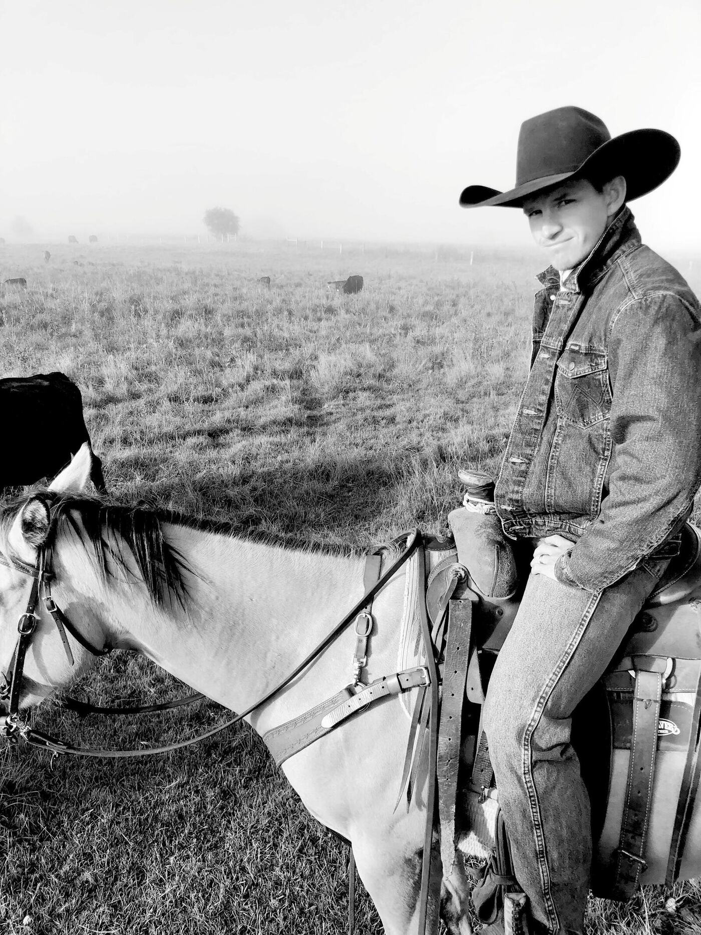 Jon Anderson on horseback in a foggy pasture