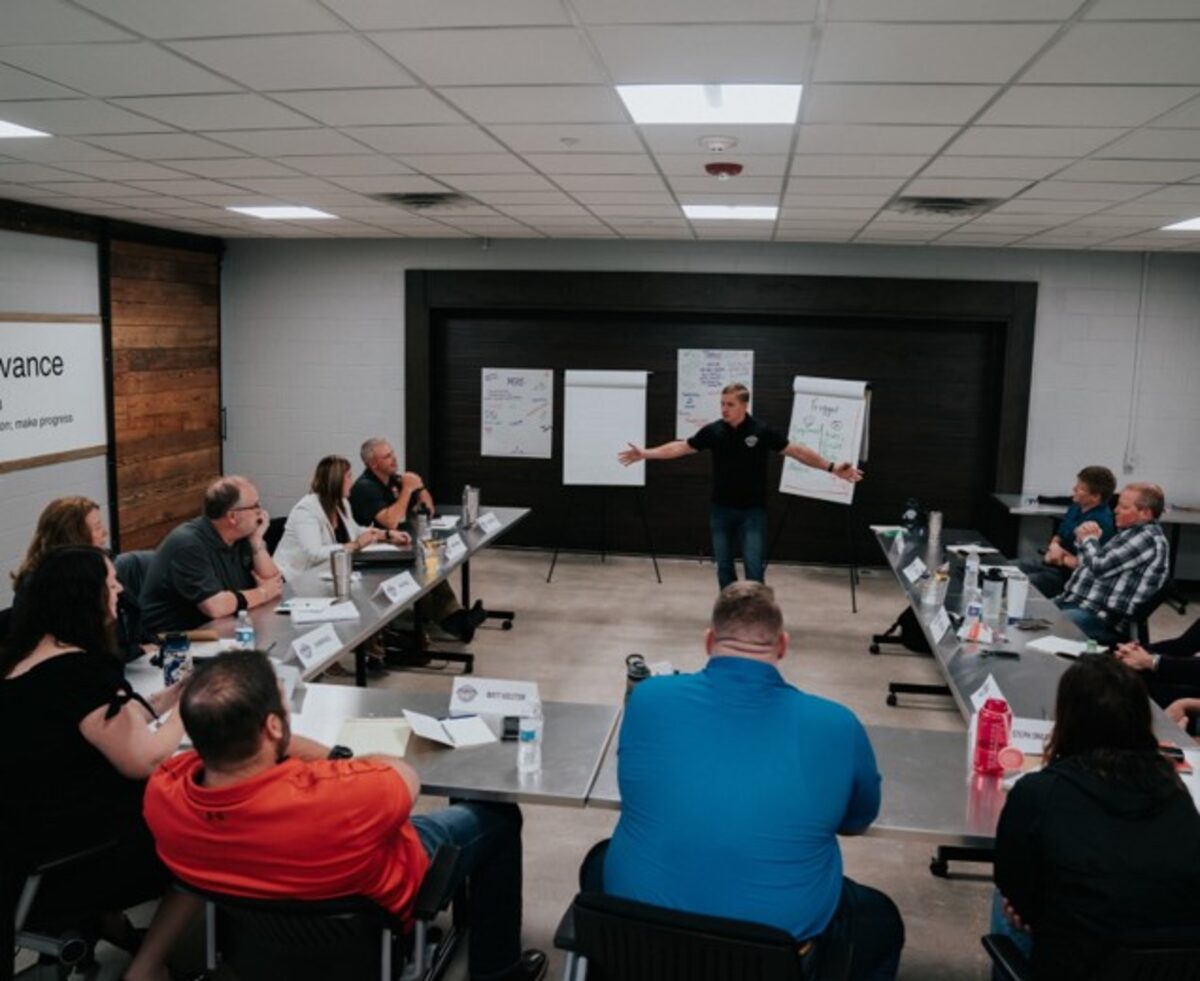 Jon Anderson presenting to a boardroom of leaders
